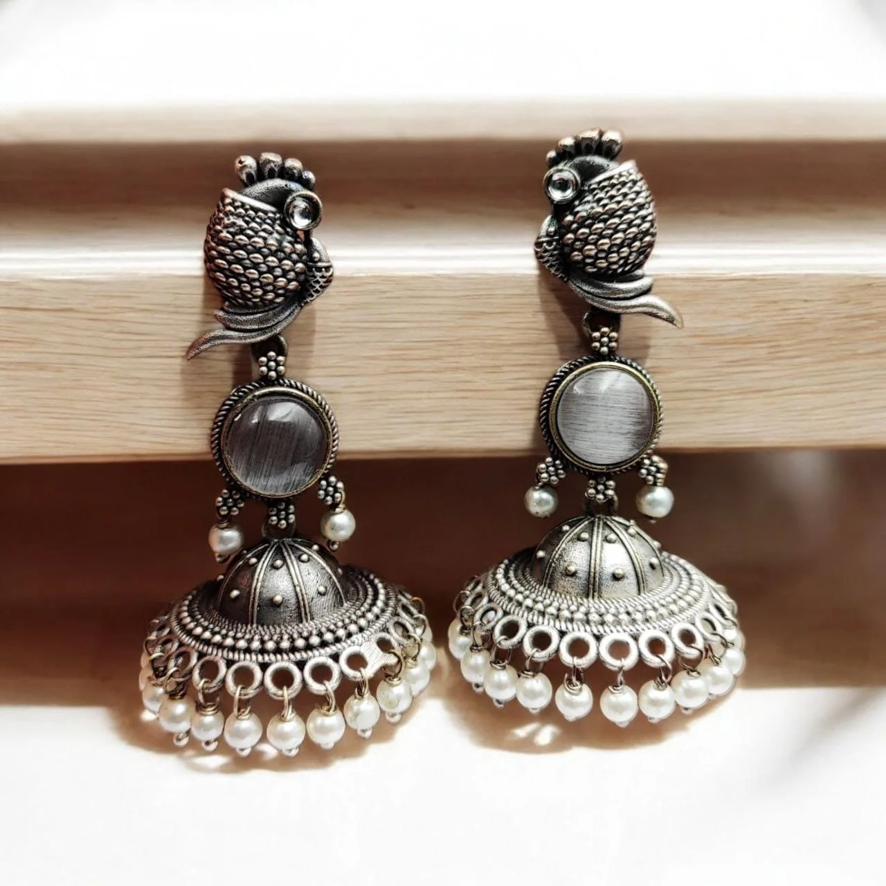 Oxidised Peacock Jhumka Earrings with Stone Medallion and Ring Cut-Work
